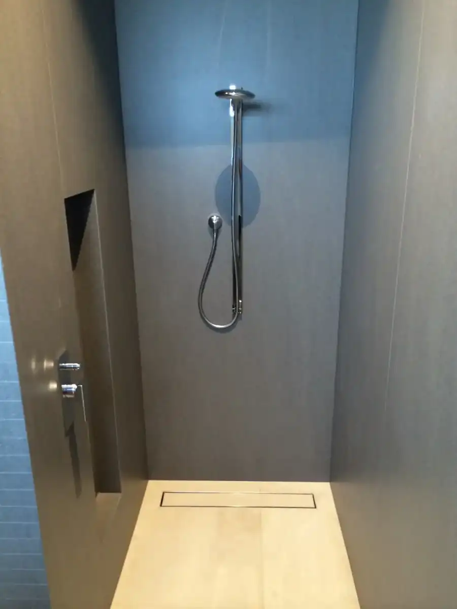 Walk-in shower with large-format panels and linear drain